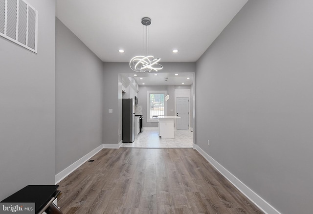 538 N Lakewood Ave, Baltimore, MD 21205 - unfurnished dining area featuring wood finished floors, a chandelier, baseboards, and recessed lighting