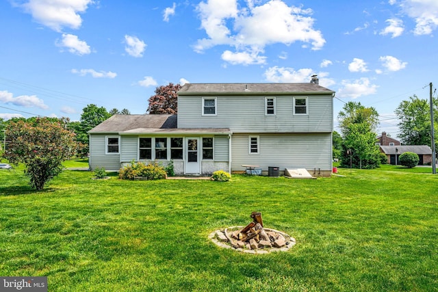 73 Swallow, Southampton, PA 18966 - rear view of property featuring an outdoor fire pit, a yard, and central AC unit
