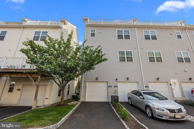 135A Equestrian Row, Bensalem, PA 19020 - rear view of house with a garage, driveway, and central air condition unit
