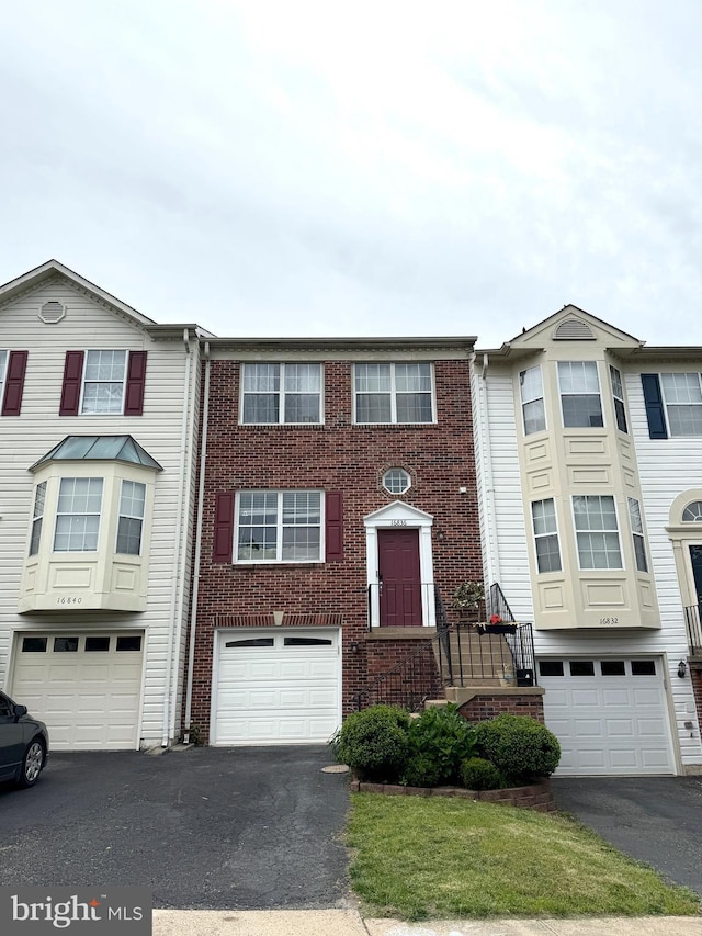 16836 Capon Tree Ln, Woodbridge, VA 22191 - view of property with driveway, an attached garage, and brick siding