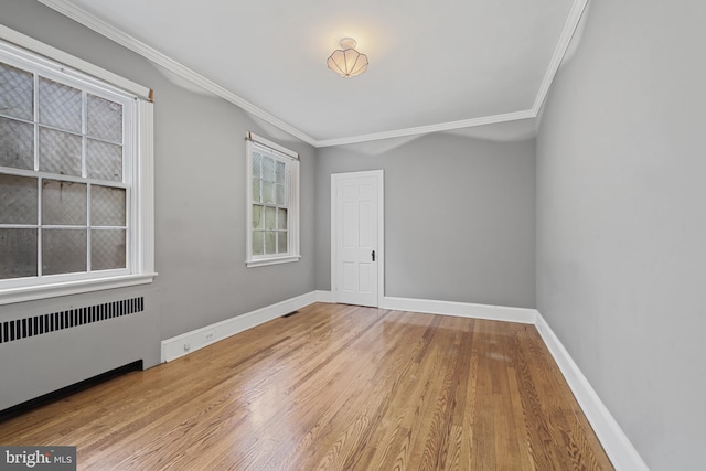 4036 Roland Ave, Baltimore, MD 21211 - empty room featuring radiator heating unit, ornamental molding, wood finished floors, and baseboards