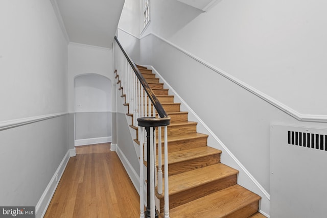4036 Roland Ave, Baltimore, MD 21211 - stairway featuring wood finished floors, arched walkways, ornamental molding, and baseboards