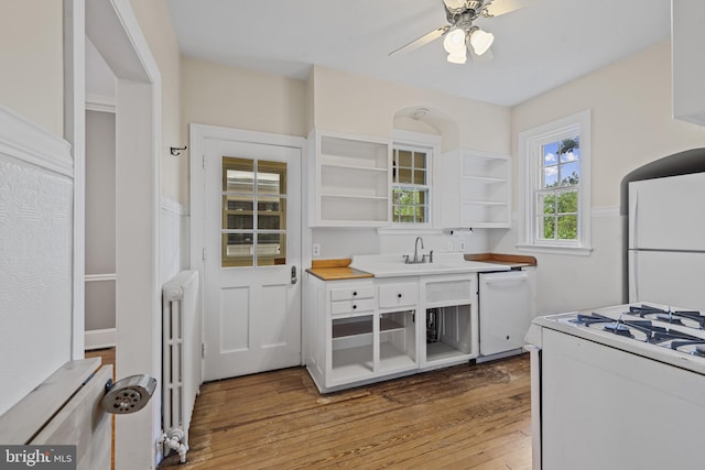 4036 Roland Ave, Baltimore, MD 21211 - kitchen featuring open shelves, white appliances, light wood-style floors, a sink, and white cabinets