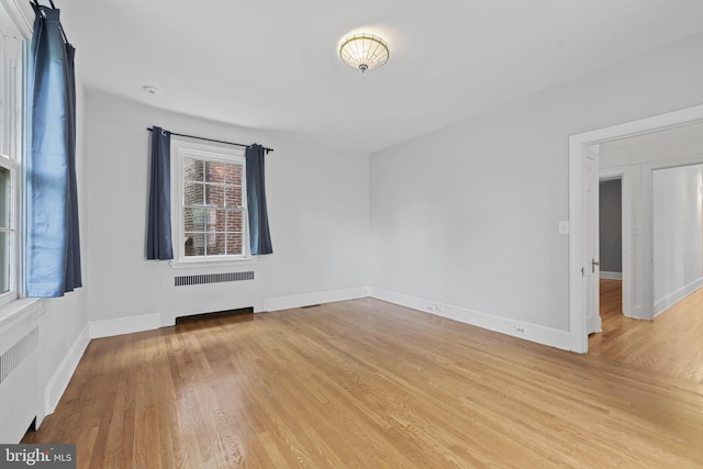 4036 Roland Ave, Baltimore, MD 21211 - empty room featuring radiator heating unit, light wood-style floors, and baseboards