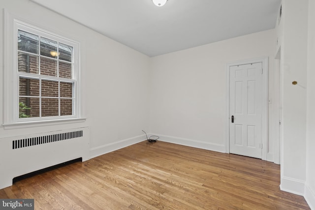 4036 Roland Ave, Baltimore, MD 21211 - spare room featuring radiator, light wood-type flooring, and baseboards