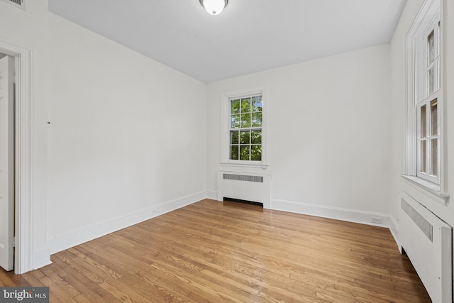 4036 Roland Ave, Baltimore, MD 21211 - empty room with radiator, light wood-style floors, and baseboards