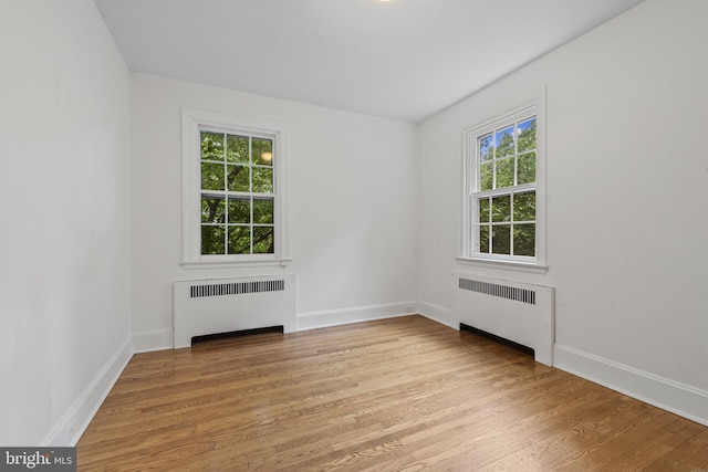 4036 Roland Ave, Baltimore, MD 21211 - empty room with radiator, light wood-type flooring, and baseboards
