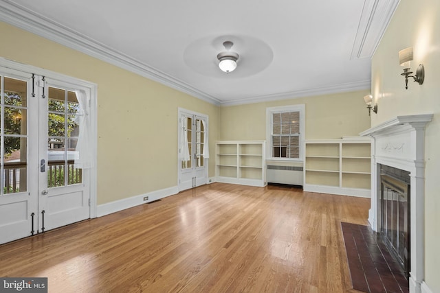 4036 Roland Ave, Baltimore, MD 21211 - unfurnished living room with radiator heating unit, ornamental molding, wood finished floors, ceiling fan, and a fireplace with flush hearth