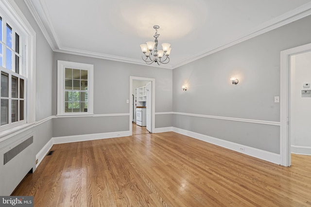 4036 Roland Ave, Baltimore, MD 21211 - unfurnished room featuring radiator heating unit, a chandelier, crown molding, wood finished floors, and baseboards
