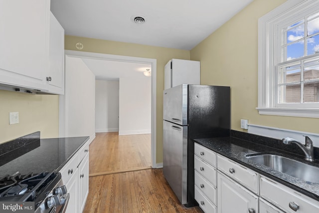 4036 Roland Ave, Baltimore, MD 21211 - kitchen with a sink, stainless steel appliances, white cabinetry, and dark wood-style floors