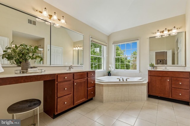 43229 Augustine Pl, Ashburn, VA 20147 - bathroom with two vanities, a garden tub, tile patterned flooring, and lofted ceiling
