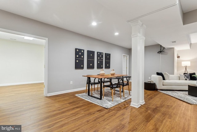 43229 Augustine Pl, Ashburn, VA 20147 - dining room featuring wood finished floors, baseboards, decorative columns, and recessed lighting