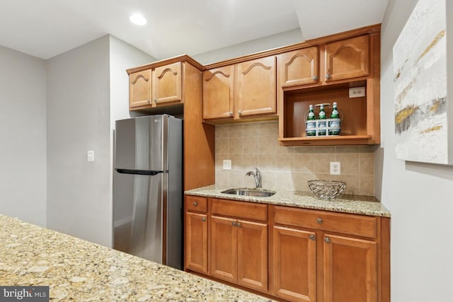 43229 Augustine Pl, Ashburn, VA 20147 - kitchen featuring freestanding refrigerator, a sink, tasteful backsplash, light stone counters, and recessed lighting