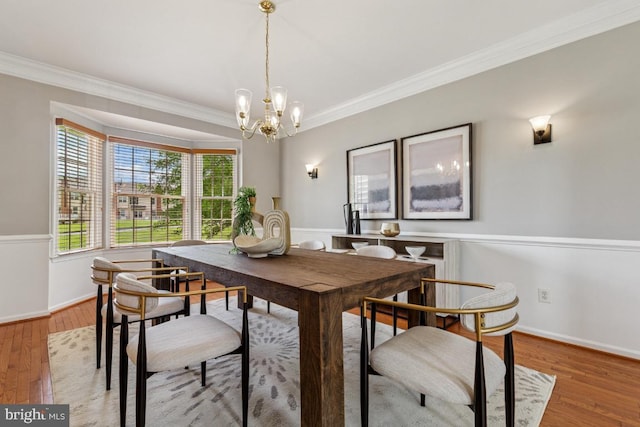 43229 Augustine Pl, Ashburn, VA 20147 - dining area with ornamental molding, a chandelier, wood finished floors, and baseboards