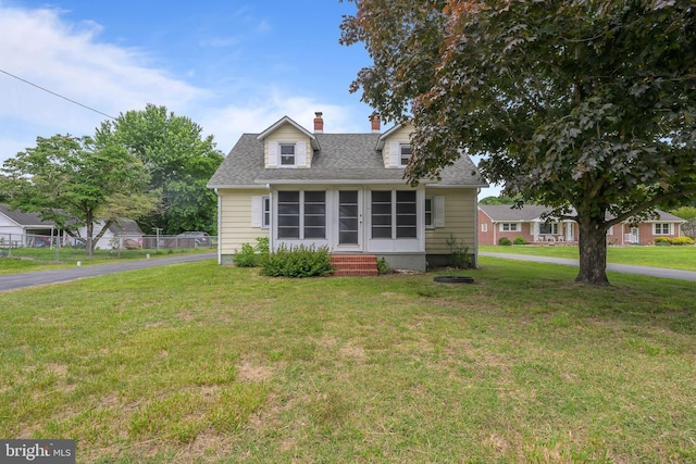 10561 Georgetown Rd, Laurel, DE 19956 - new england style home featuring entry steps, a front lawn, a chimney, a shingled roof, and a sunroom