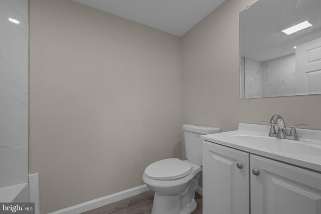 10561 Georgetown Rd, Laurel, DE 19956 - full bath with vanity, toilet, wood finished floors, baseboards, and a bath