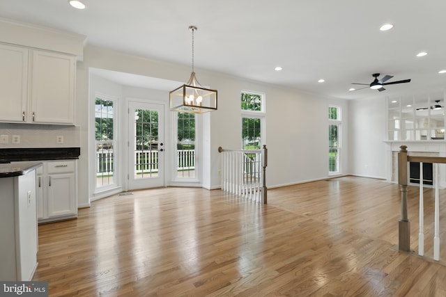 43175 Burstall Ct, Leesburg, VA 20176 - unfurnished living room featuring recessed lighting, light wood-style floors, a chandelier, ceiling fan, and baseboards