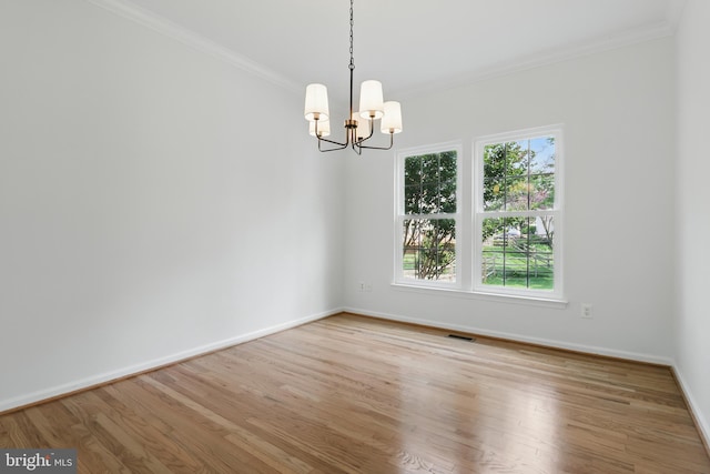 43175 Burstall Ct, Leesburg, VA 20176 - spare room featuring ornamental molding, plenty of natural light, a chandelier, baseboards, and wood finished floors