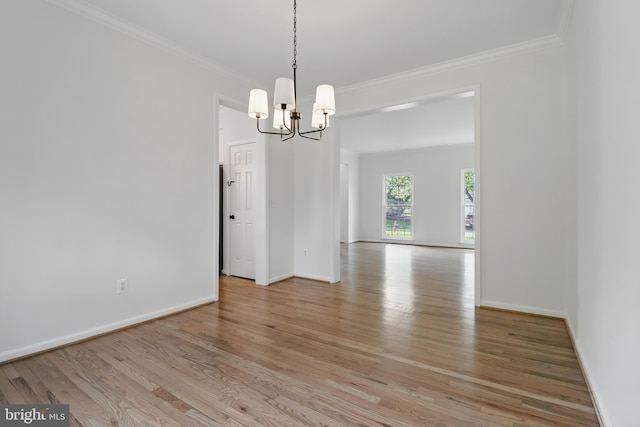 43175 Burstall Ct, Leesburg, VA 20176 - spare room with a chandelier, crown molding, light wood finished floors, and baseboards