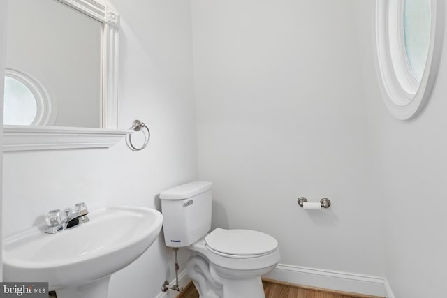 43175 Burstall Ct, Leesburg, VA 20176 - half bathroom featuring a sink, baseboards, toilet, and wood finished floors