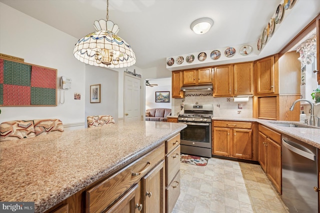1004 Truman Rd, East Norriton, PA 19403 - kitchen featuring stainless steel appliances, under cabinet range hood, a sink, tasteful backsplash, and light stone counters
