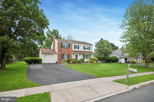 1004 Truman Rd, East Norriton, PA 19403 - view of front of house featuring an attached garage, a front lawn, driveway, a chimney, and brick siding