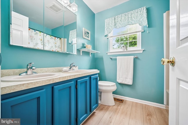 1004 Truman Rd, East Norriton, PA 19403 - bathroom featuring toilet, wood finished floors, double vanity, baseboards, and a shower with curtain