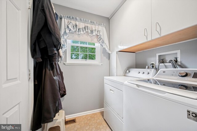 1004 Truman Rd, East Norriton, PA 19403 - laundry area with cabinet space, washer and clothes dryer, and baseboards
