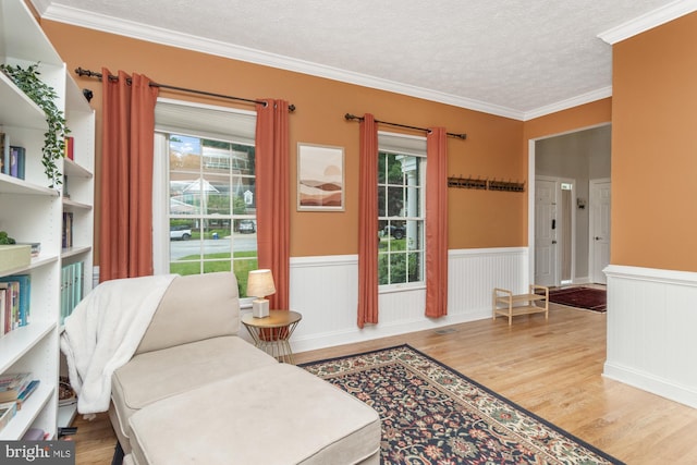 8 Lochwell Ct, Baltimore, MD 21234 - living area with plenty of natural light, wood finished floors, a wainscoted wall, a textured ceiling, and crown molding