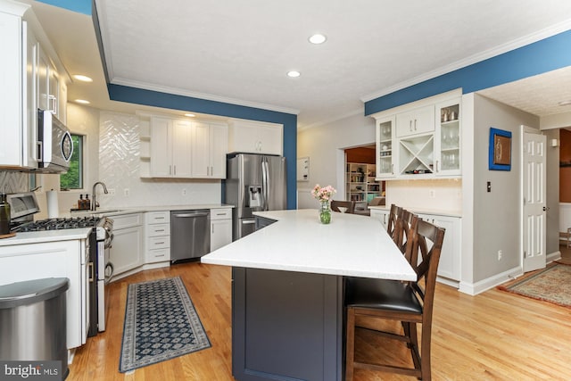 8 Lochwell Ct, Baltimore, MD 21234 - kitchen with appliances with stainless steel finishes, open shelves, a kitchen breakfast bar, a kitchen island, and light countertops