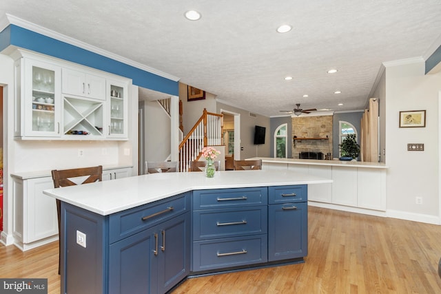 8 Lochwell Ct, Baltimore, MD 21234 - kitchen featuring blue cabinets, a ceiling fan, white cabinets, light countertops, and light wood finished floors