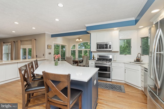 8 Lochwell Ct, Baltimore, MD 21234 - kitchen featuring stainless steel appliances, a sink, recessed lighting, a kitchen bar, and white cabinets