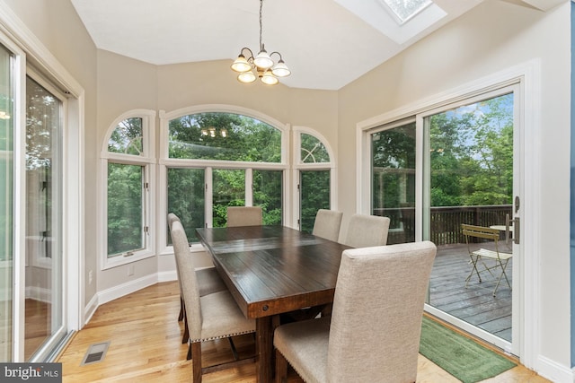 8 Lochwell Ct, Baltimore, MD 21234 - dining space with light wood-type flooring, a chandelier, a skylight, and baseboards
