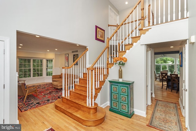 8 Lochwell Ct, Baltimore, MD 21234 - staircase featuring wood finished floors, a towering ceiling, recessed lighting, and baseboards