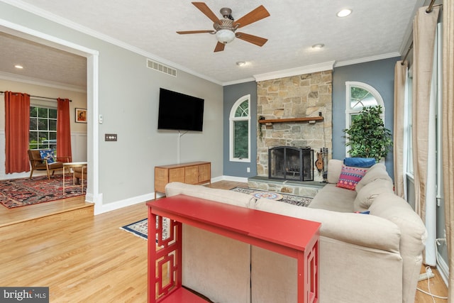 8 Lochwell Ct, Baltimore, MD 21234 - living room featuring light wood-style flooring, healthy amount of natural light, a ceiling fan, a fireplace, and ornamental molding