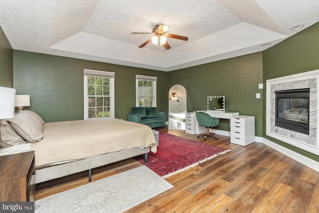 8 Lochwell Ct, Baltimore, MD 21234 - bedroom with a raised ceiling, a premium fireplace, hardwood / wood-style flooring, baseboards, and a textured ceiling