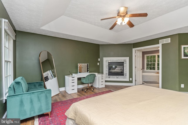 8 Lochwell Ct, Baltimore, MD 21234 - bedroom featuring a raised ceiling, wood finished floors, a textured ceiling, a high end fireplace, and baseboards