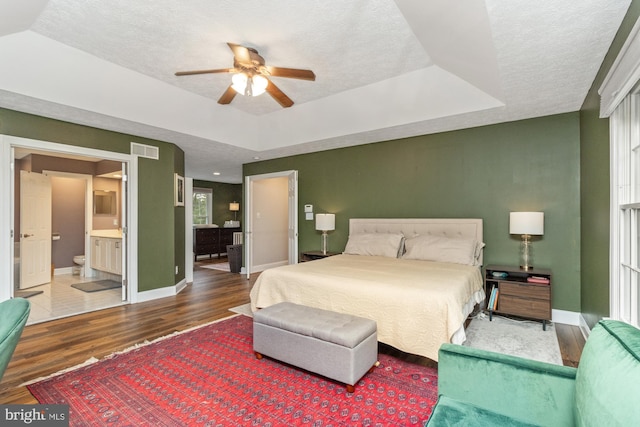 8 Lochwell Ct, Baltimore, MD 21234 - bedroom with wood finished floors, a textured ceiling, baseboards, a raised ceiling, and ensuite bathroom