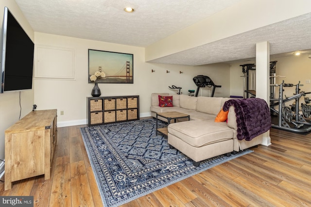8 Lochwell Ct, Baltimore, MD 21234 - living area featuring a textured ceiling, wood-type flooring, and baseboards