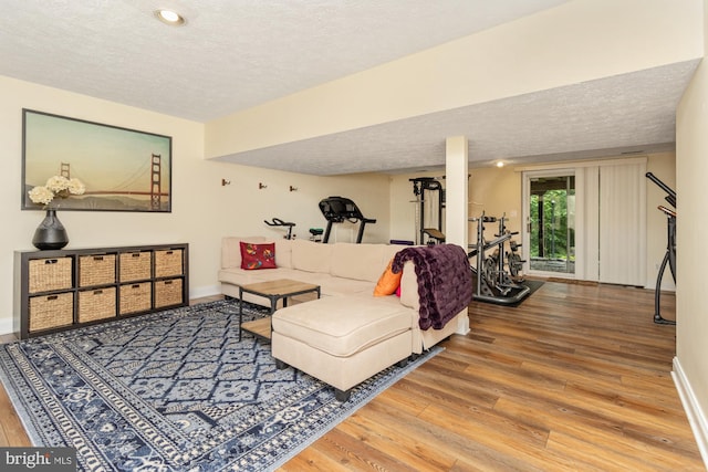 8 Lochwell Ct, Baltimore, MD 21234 - living area featuring a textured ceiling, wood-type flooring, and baseboards