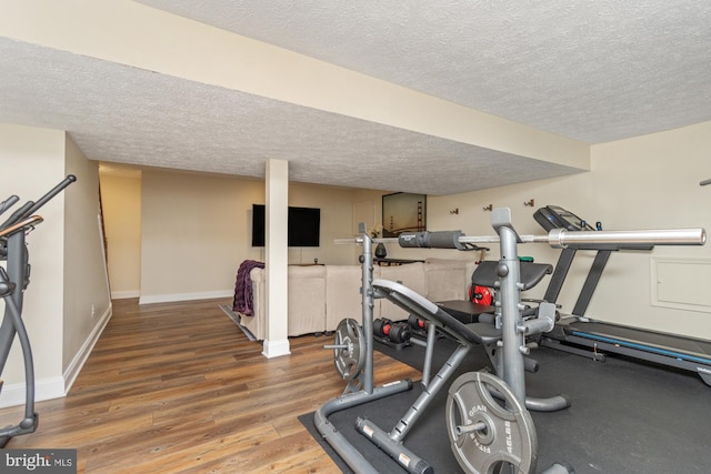 8 Lochwell Ct, Baltimore, MD 21234 - exercise area with a textured ceiling, wood finished floors, and baseboards