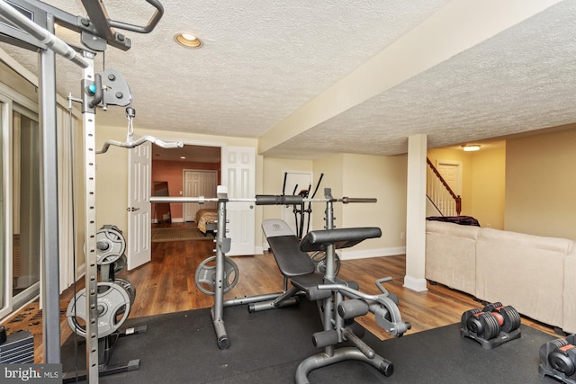 8 Lochwell Ct, Baltimore, MD 21234 - workout room featuring a textured ceiling, baseboards, and wood finished floors