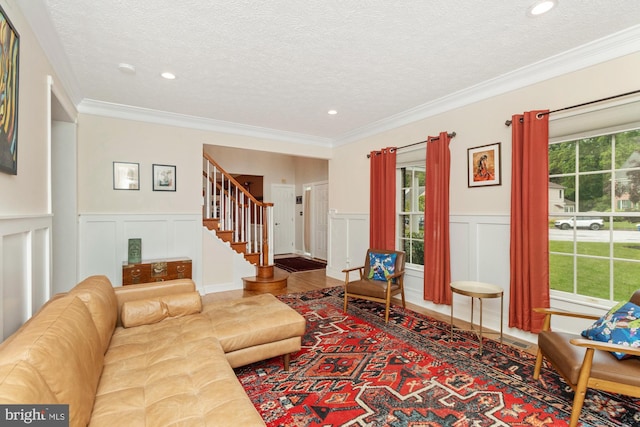 8 Lochwell Ct, Baltimore, MD 21234 - living room featuring stairway, a textured ceiling, a decorative wall, and a wainscoted wall