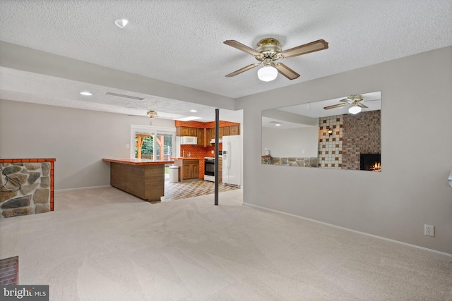 13712 S Springfield Rd, Brandywine, MD 20613 - living area with a fireplace, light colored carpet, ceiling fan, baseboards, and a textured ceiling