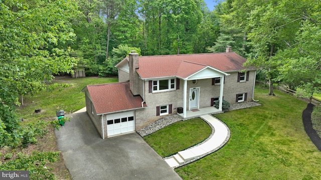 13712 S Springfield Rd, Brandywine, MD 20613 - raised ranch with a chimney, a garage, driveway, a front yard, and roof with shingles