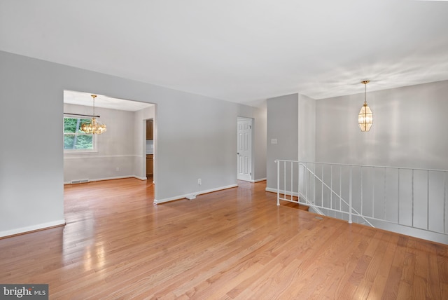 13712 S Springfield Rd, Brandywine, MD 20613 - spare room featuring a chandelier, light wood-style floors, and baseboards