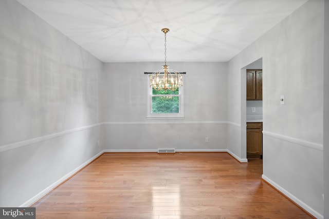13712 S Springfield Rd, Brandywine, MD 20613 - unfurnished room featuring a chandelier, light wood-type flooring, and baseboards