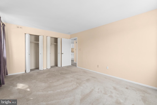 6017 Majors Ln Unit 3, Columbia, MD 21045 - unfurnished bedroom featuring multiple closets and carpet