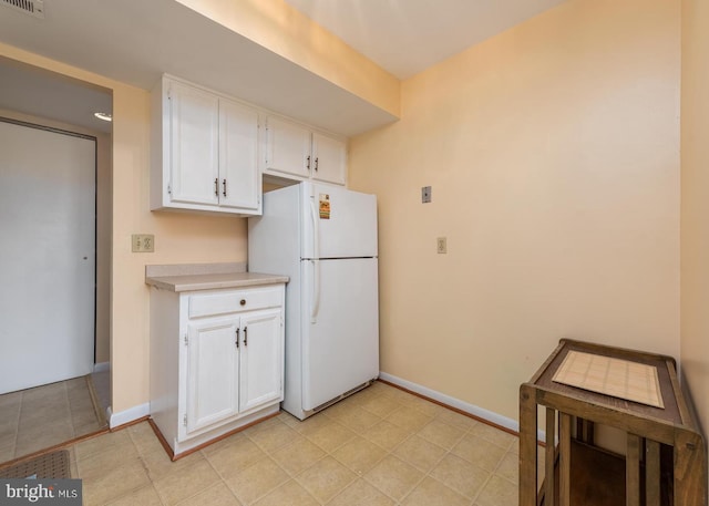 6017 Majors Ln Unit 3, Columbia, MD 21045 - kitchen featuring freestanding refrigerator, white cabinets, light countertops, and baseboards