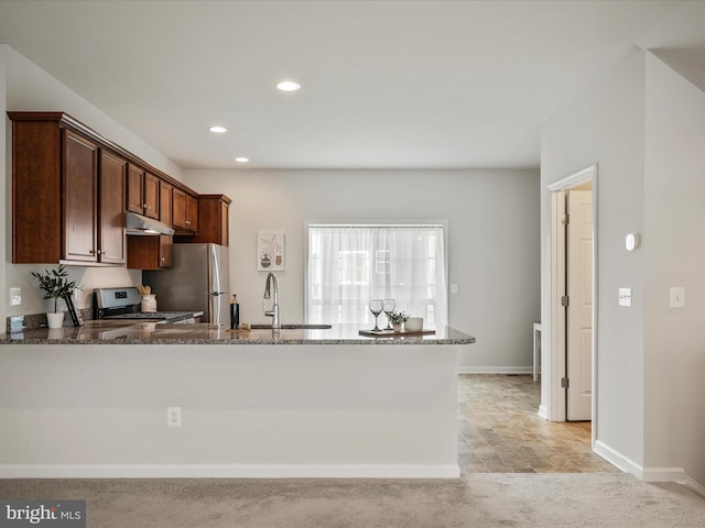 262 Norland Knoll Dr, Stephenson, VA 22656 - kitchen featuring stainless steel appliances, dark stone counters, recessed lighting, a peninsula, and under cabinet range hood